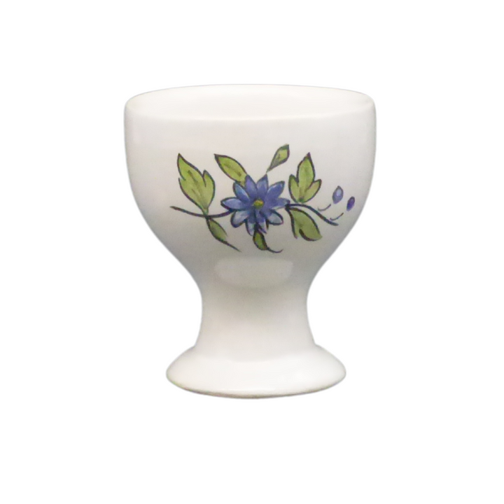 Simple egg cup with a blue hand painted flower
